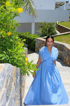 Cornflower blue floral-waist maxi dress worn on a sunny garden pathway