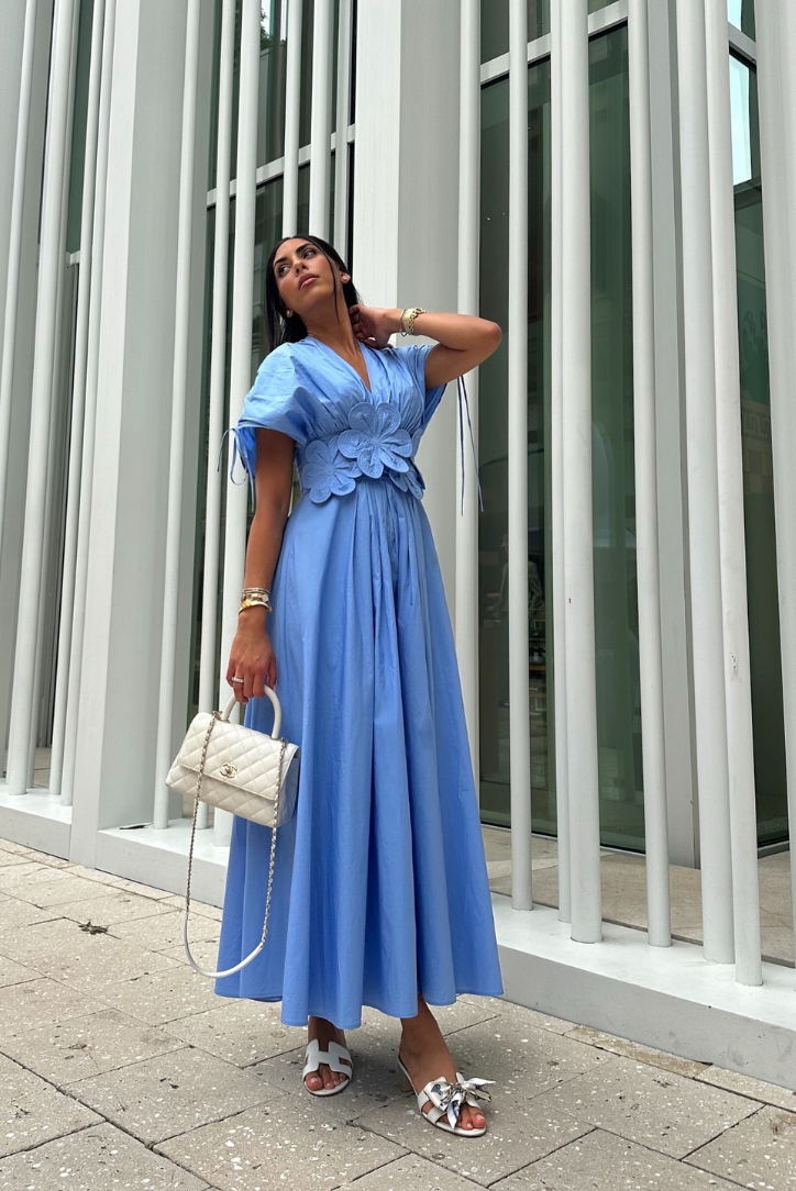 Cornflower blue puff-sleeve maxi dress paired with a white handbag