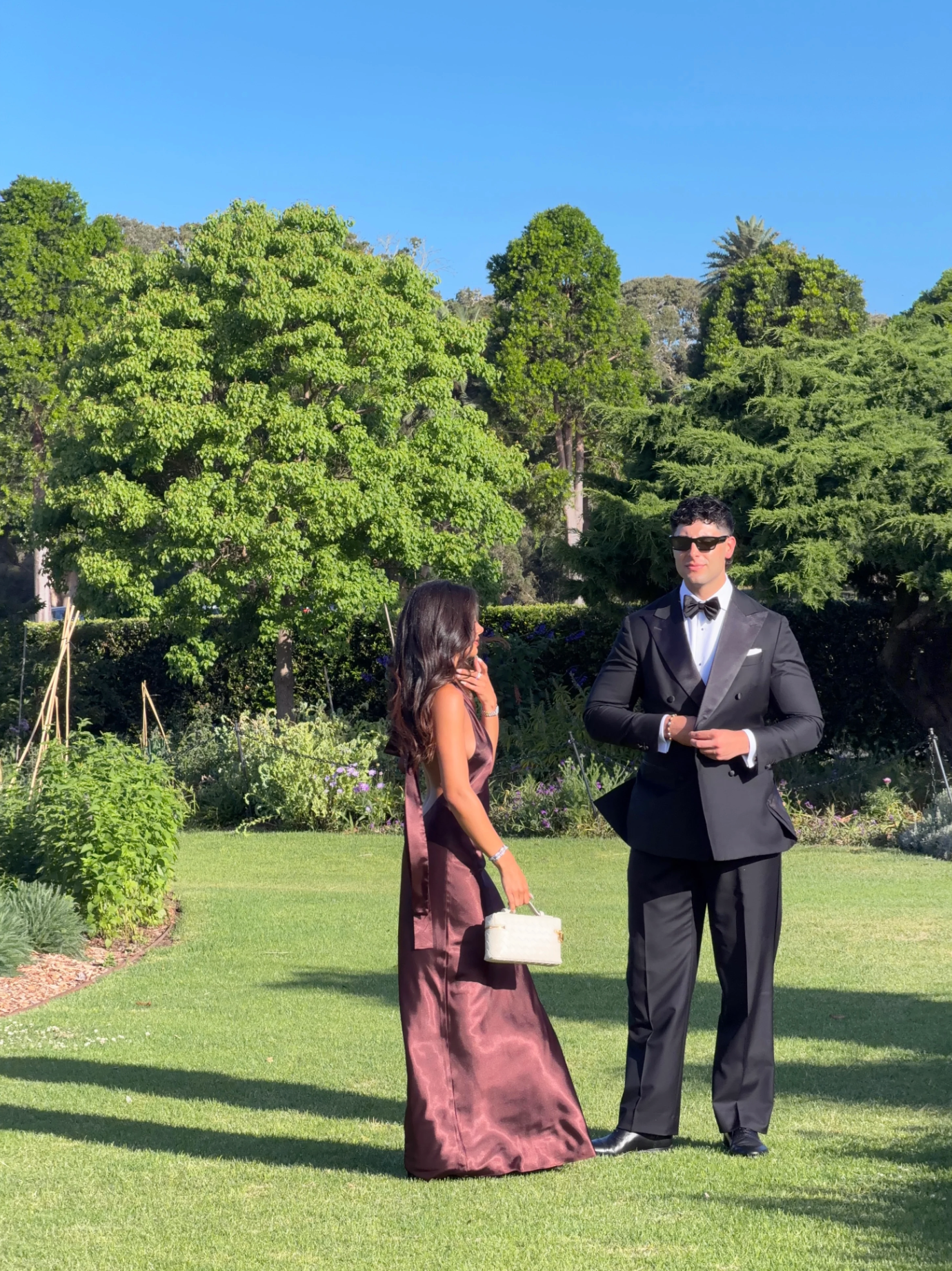 Brown satin halter maxi dress styled for an outdoor evening event