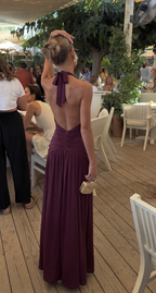 Red halter maxi dress showing the daring thigh-high slit