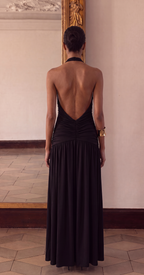 Black halter maxi dress showing the daring thigh-high slit