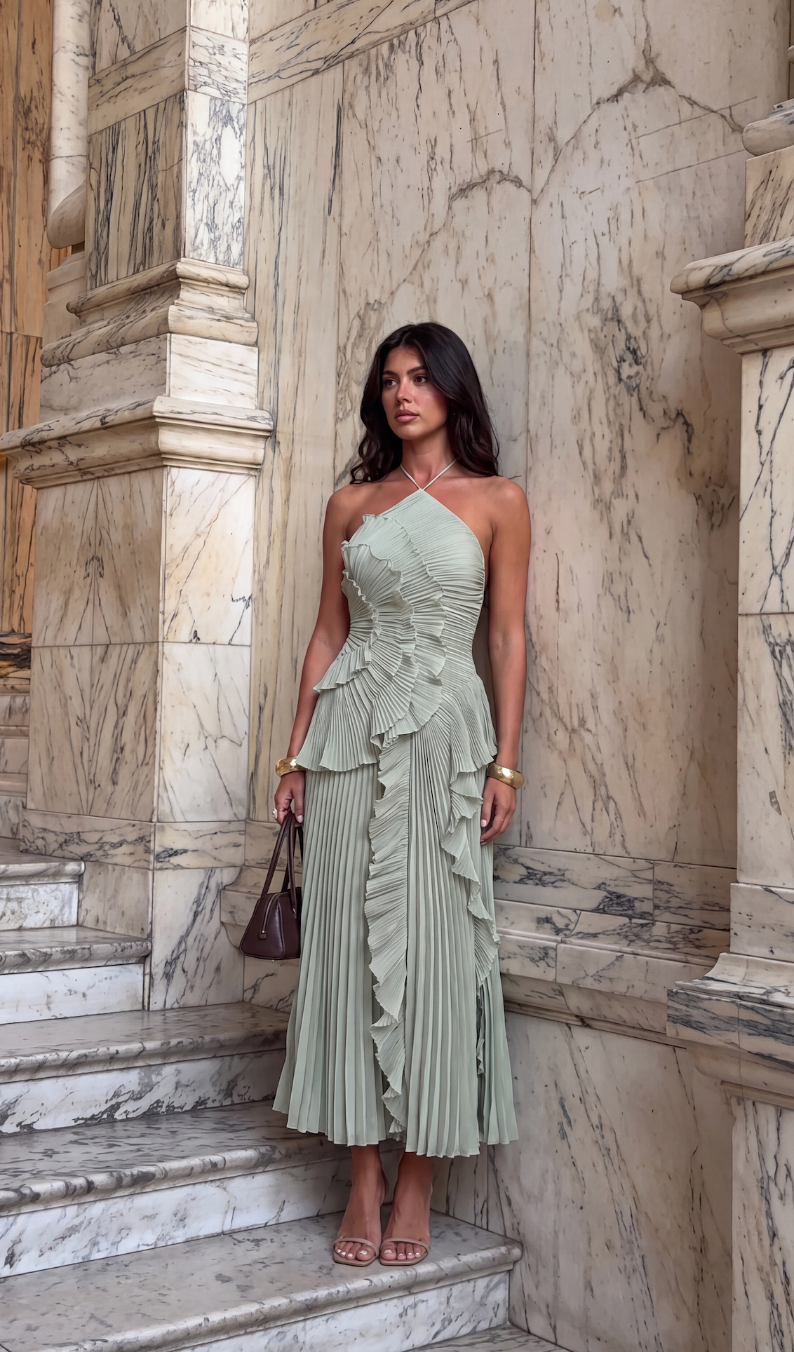 Mint halter maxi dress styled with a shoulder bag on stone steps