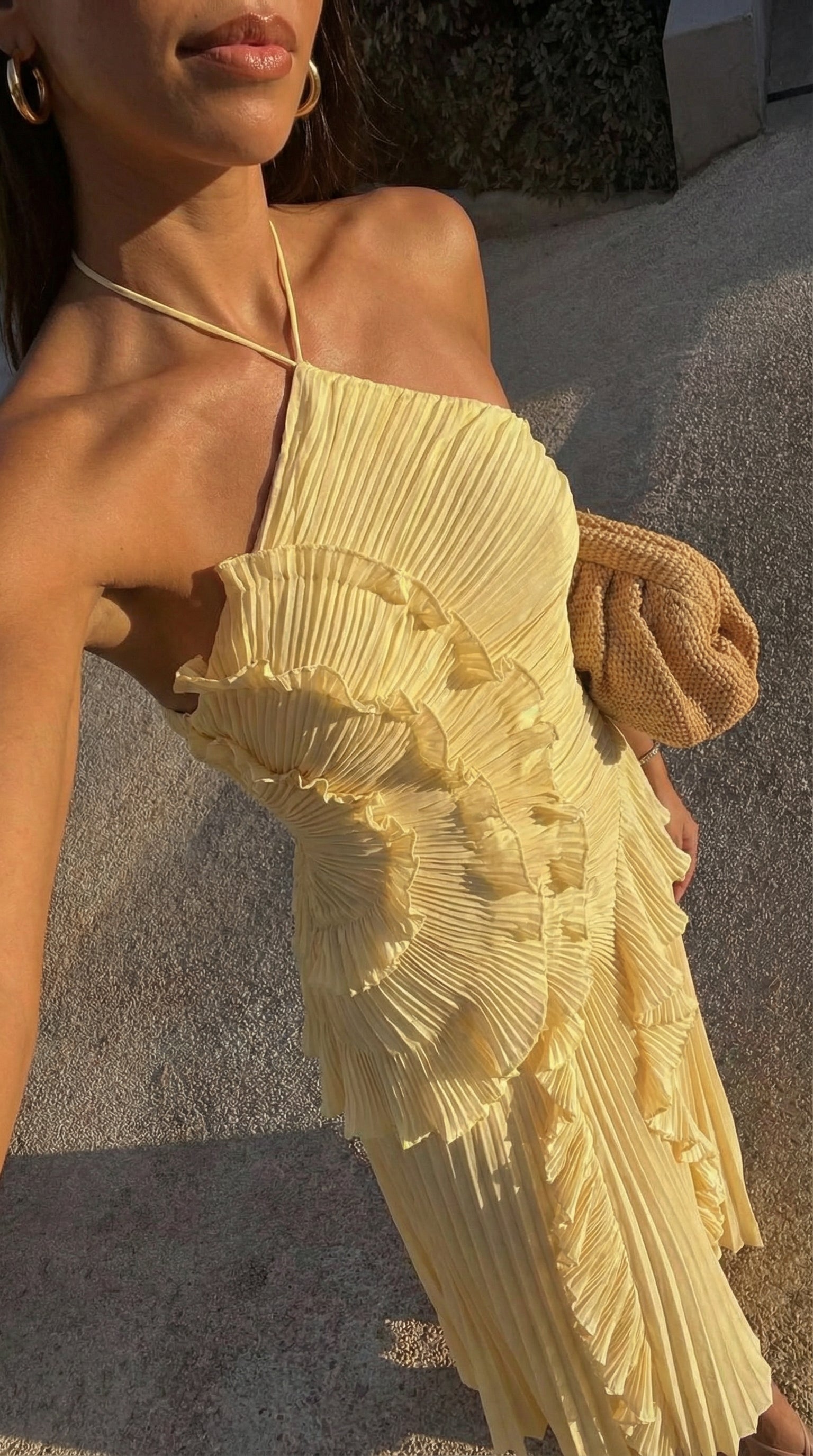 Close-up of yellow ruffle detail on halter maxi dress shoulder