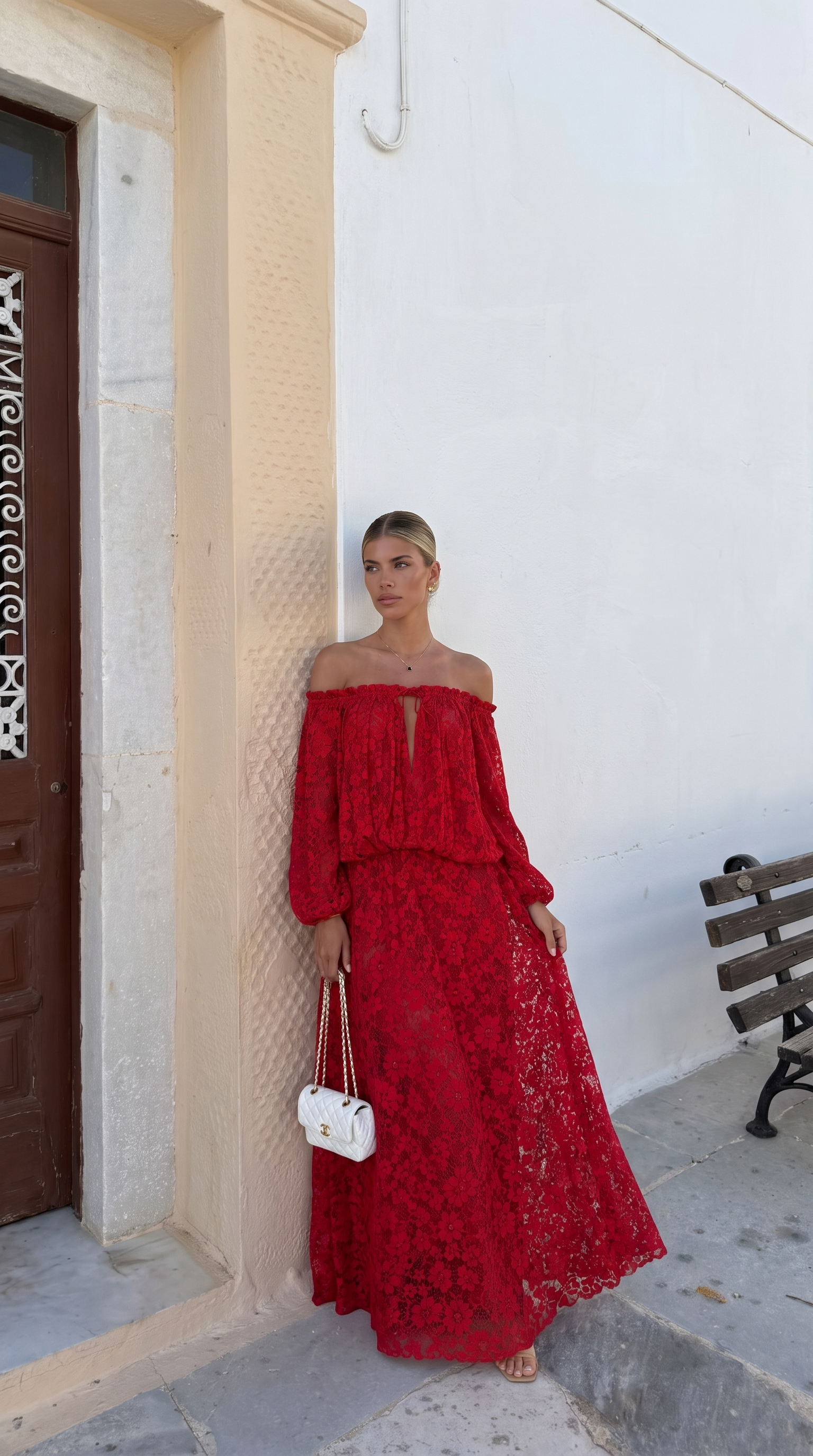 Red off-shoulder lace maxi dress worn at a stone doorway