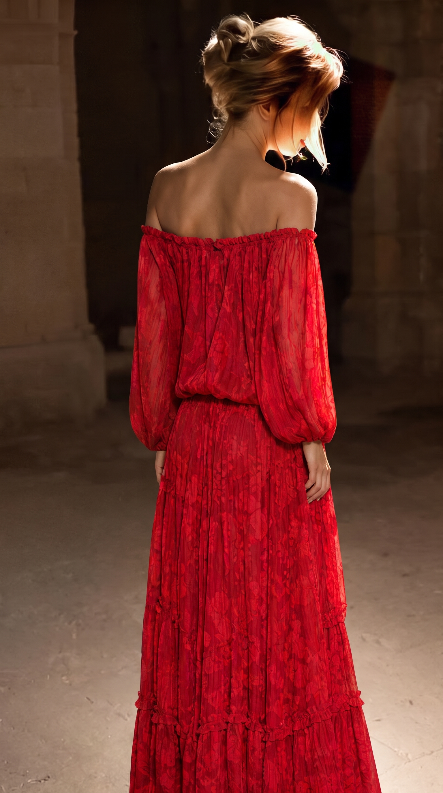 Red off-shoulder lace maxi dress with long sleeves, back view in a stone archway