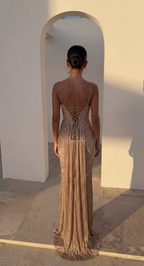 Full-length look at the gold corset maxi dress and its corset-style bodice.