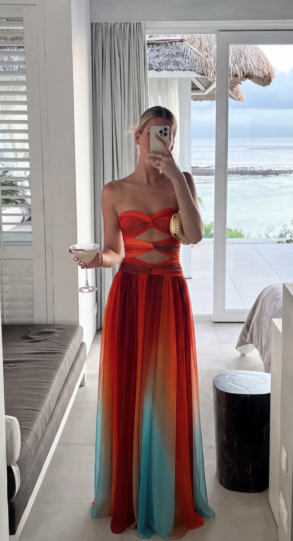 Multicolour ombre strapless maxi dress worn seaside with a balcony view