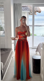 Multicolour ombre strapless maxi dress worn seaside with a balcony view