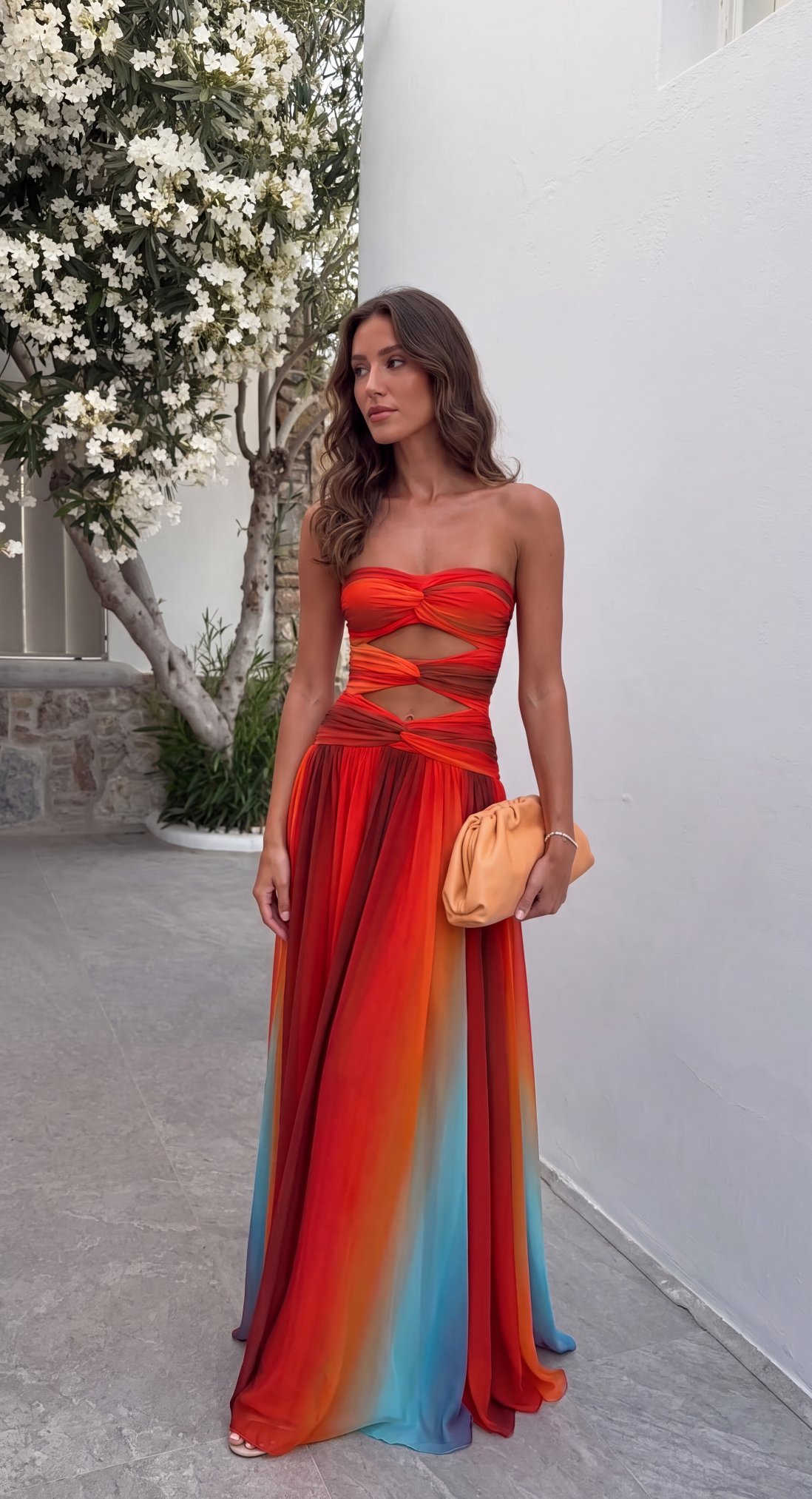 Multicolour ombre strapless maxi dress styled with a straw bag on a garden path