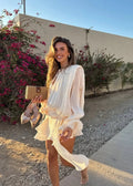 Beige ruffled mini dress with wide sleeves, shown from the front