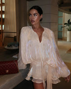 Close-up of the beige ruffled mini dress pleated bodice detail