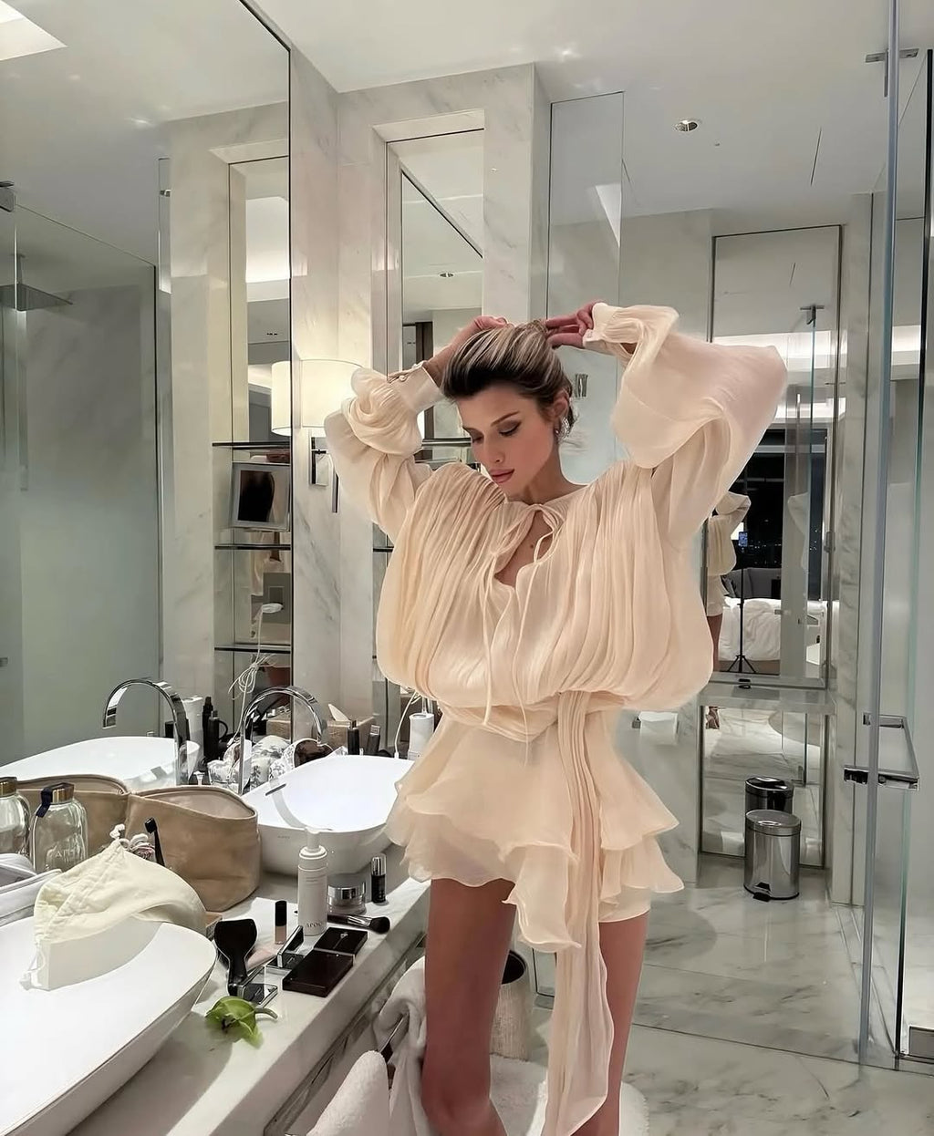 Beige ruffled mini dress hem captured in flowing movement