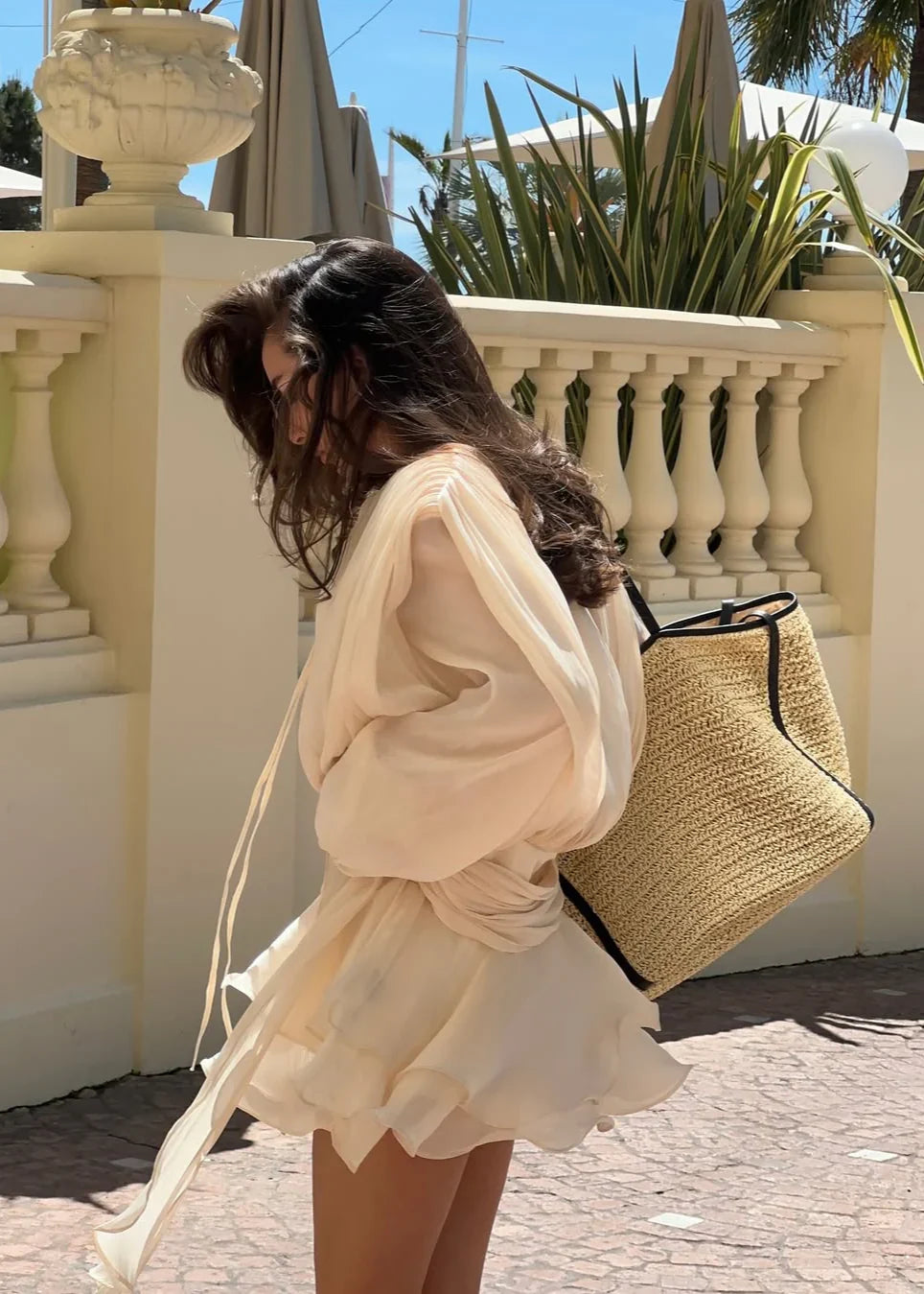 Close-up of the wide, voluminous sleeve on this beige mini dress