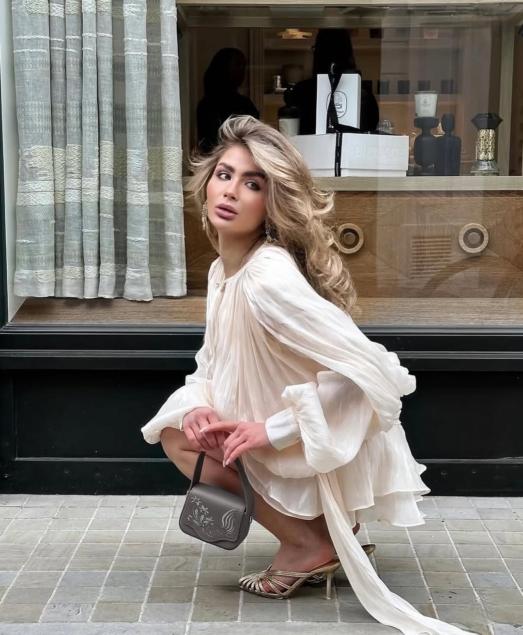 Beige ruffled mini dress styled for an evening occasion