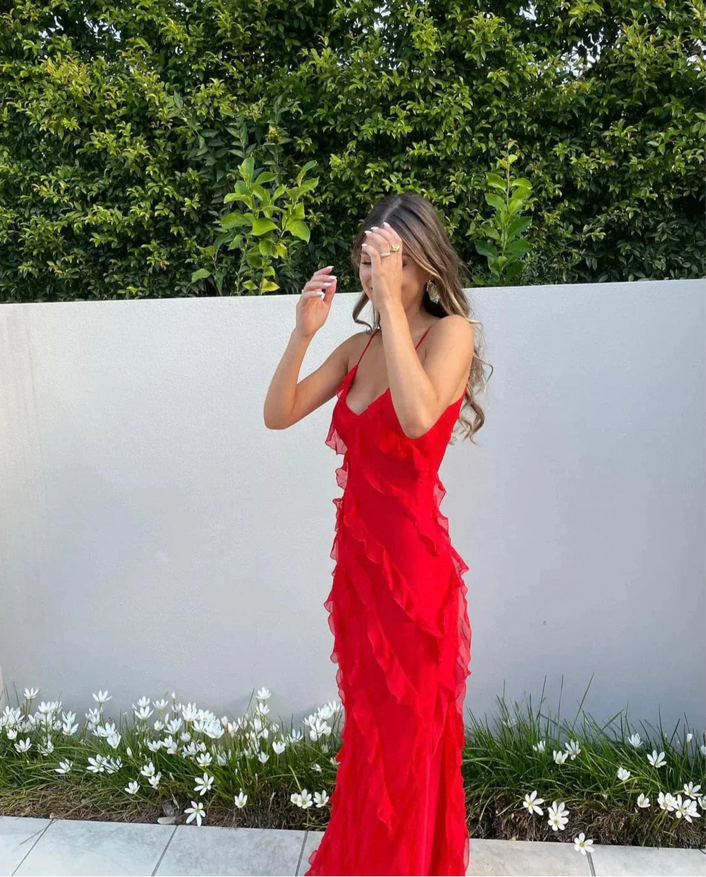Red off-shoulder maxi dress styled for a wedding or garden party