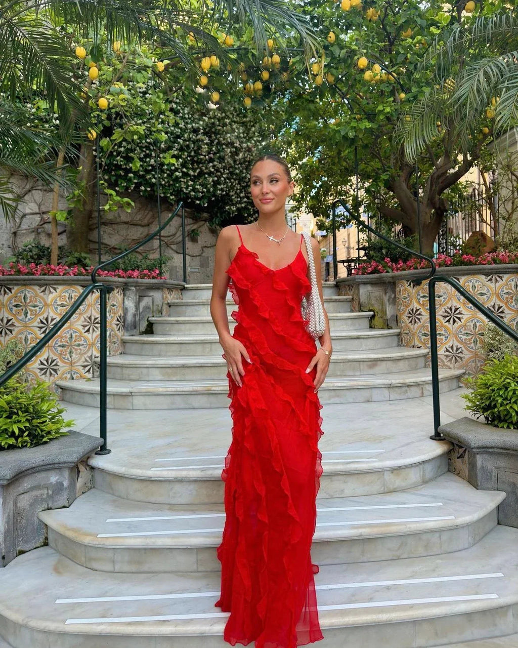 Red off-shoulder maxi dress with a flowing, fluid silhouette