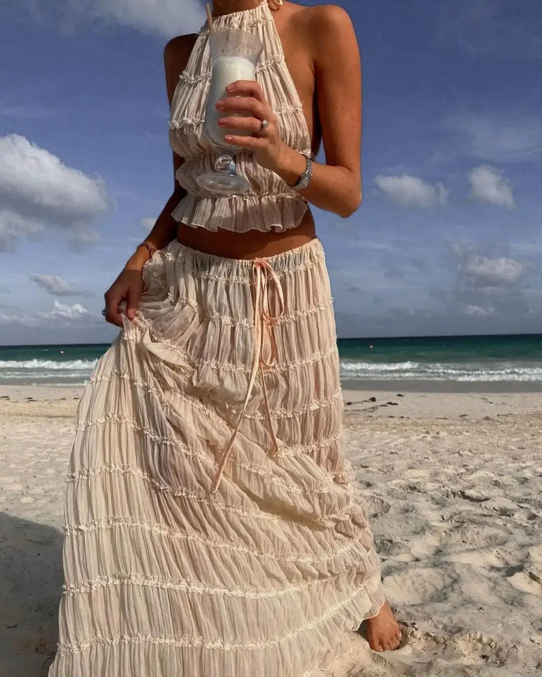 Cream ruffle halter two-piece set, back view on the beach