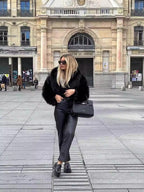 Black faux fur coat styled open over an outfit, front view