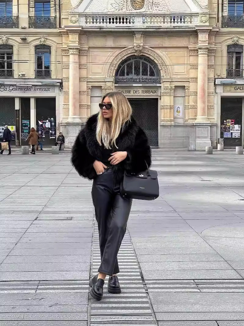 Black faux fur coat styled open over an outfit, front view