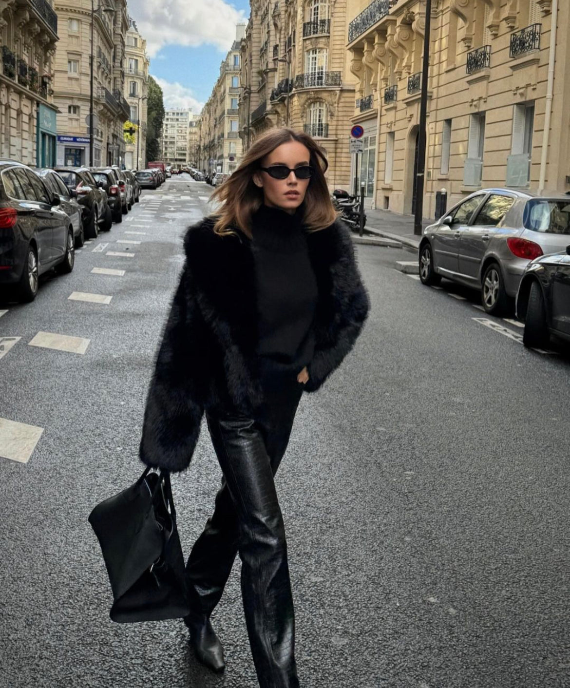 Black faux fur coat sleeve and cuff detail, close-up