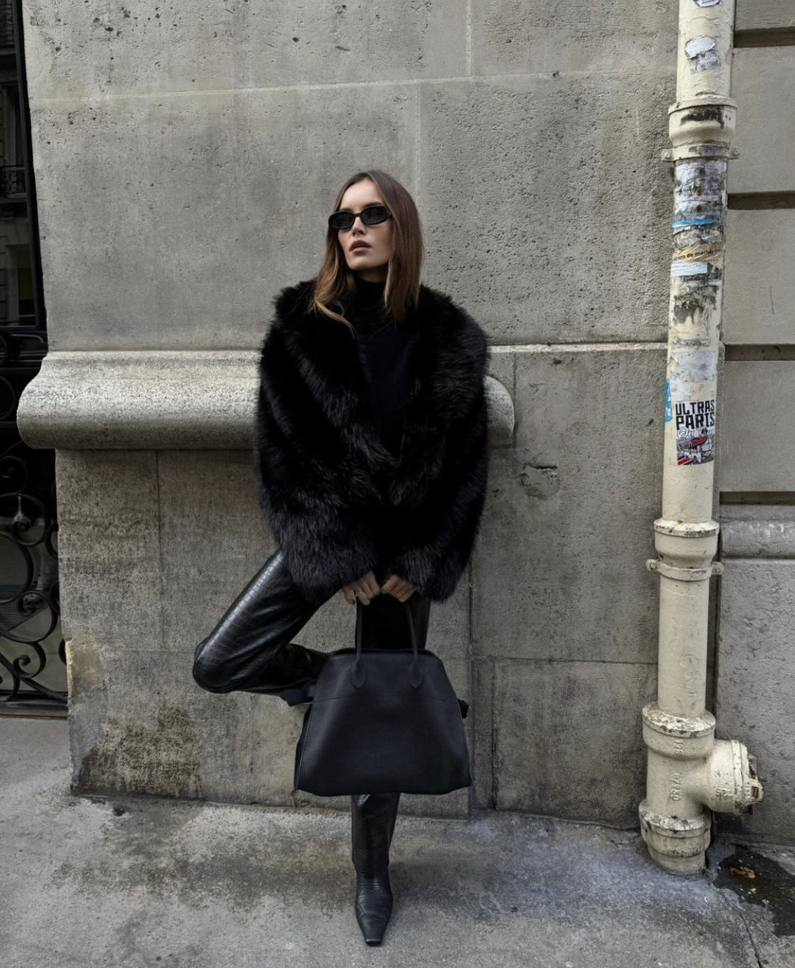 Black faux fur coat back view showing the oversized fit