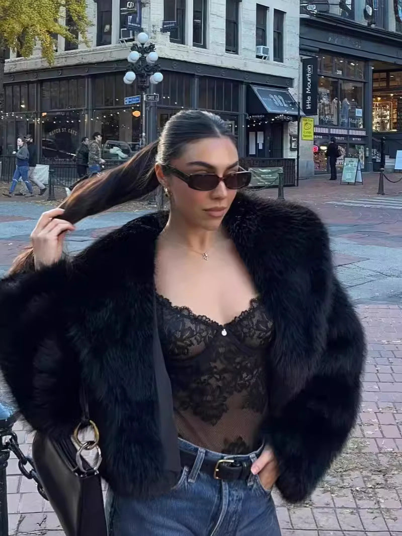 Black faux fur coat hook and eye closure detail, close-up