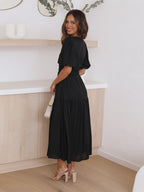 The White maxi dress worn in a lifestyle setting to show how it falls