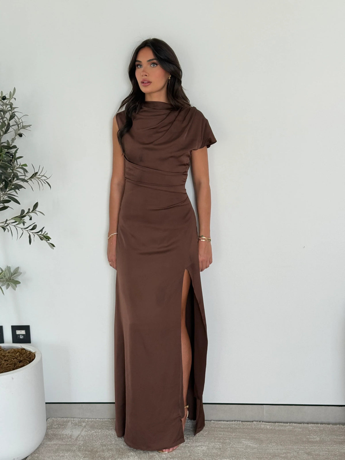 Brown satin maxi dress with a draped neckline, side profile