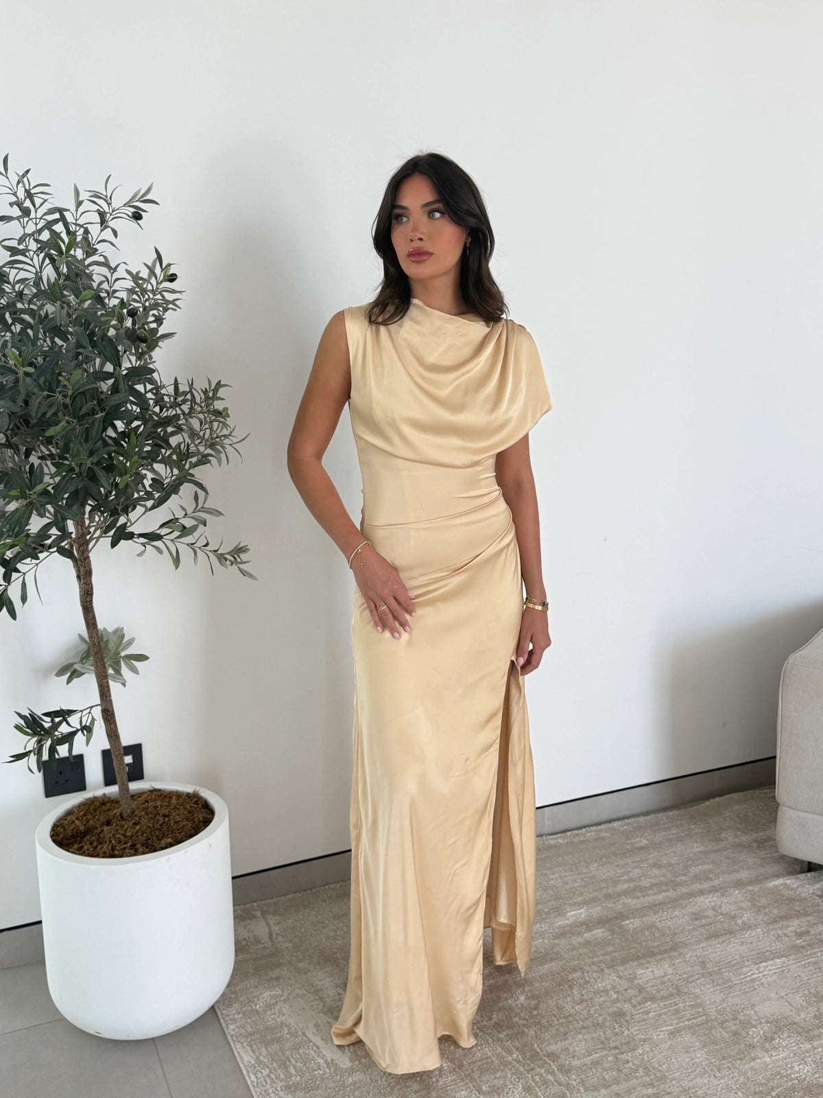 Champagne satin maxi dress with a draped neckline, full-length shot