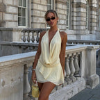Front view of the butter yellow mini dress featuring open-back tie detail.