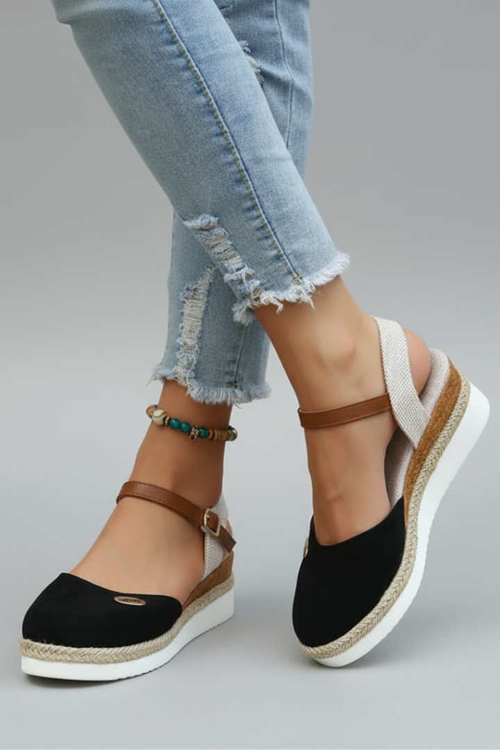 Black espadrille sandals with a slingback strap and rounded toe