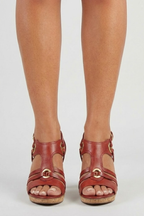 Red heeled sandals showing the adjustable side buckle closure