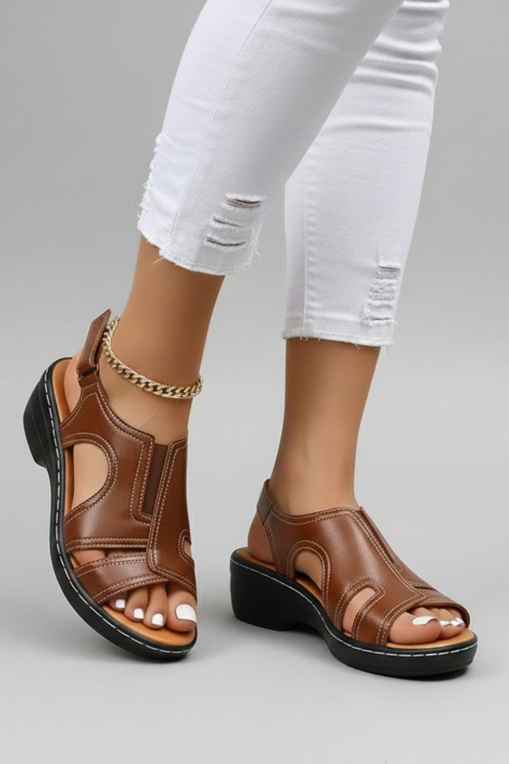 Brown platform sandals with ankle strap worn with cropped jeans