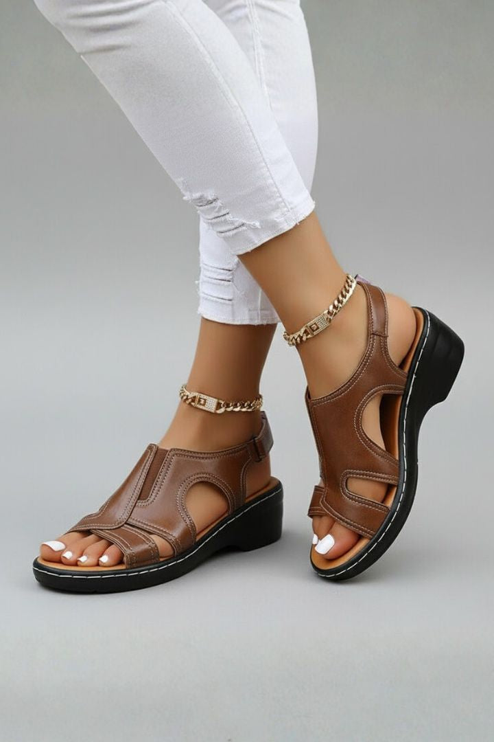 Brown cutout platform sandals worn with white jeans, side view