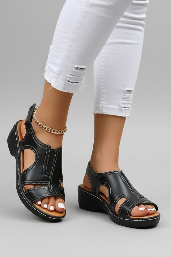 Black cutout platform sandals worn with white jeans