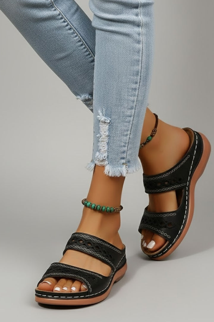 Close-up of the Red slide sandals trim, finish and hardware detail