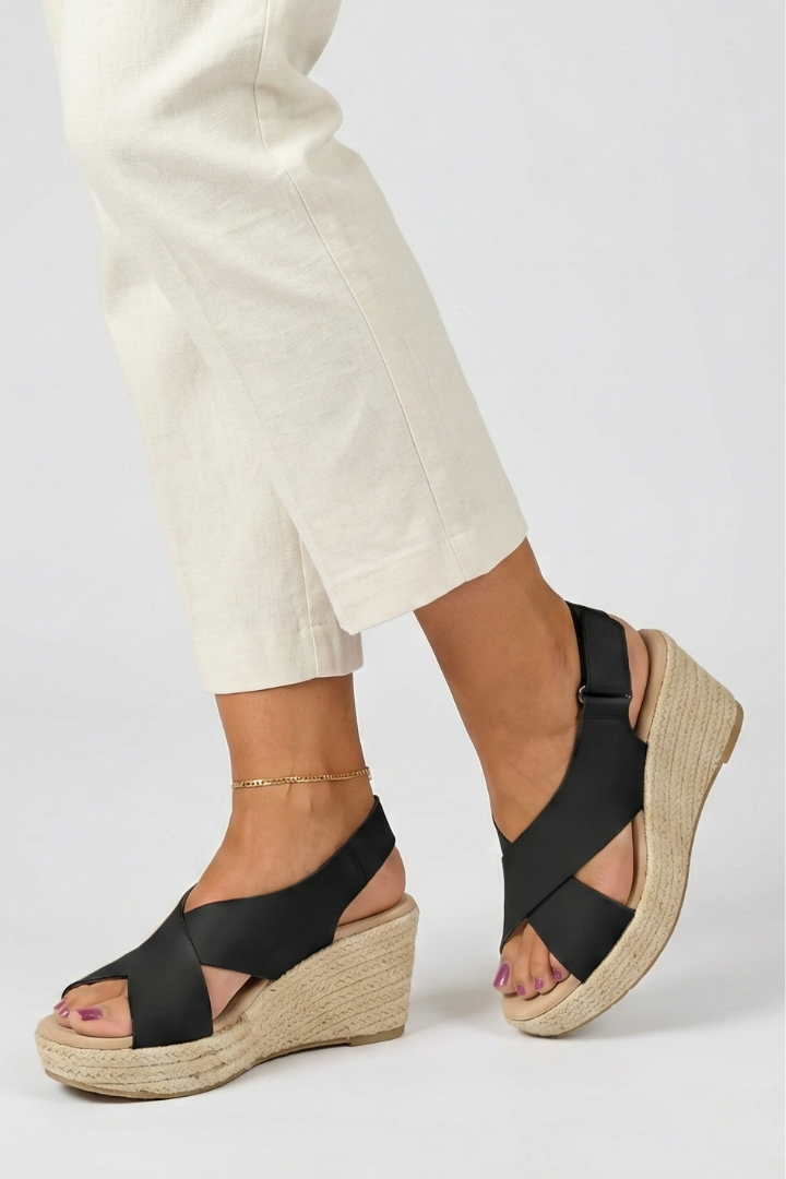 Black espadrille wedge sandals styled with linen trousers, side view