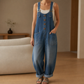 Denim wide-leg dungarees layered over a white top, indoor styling