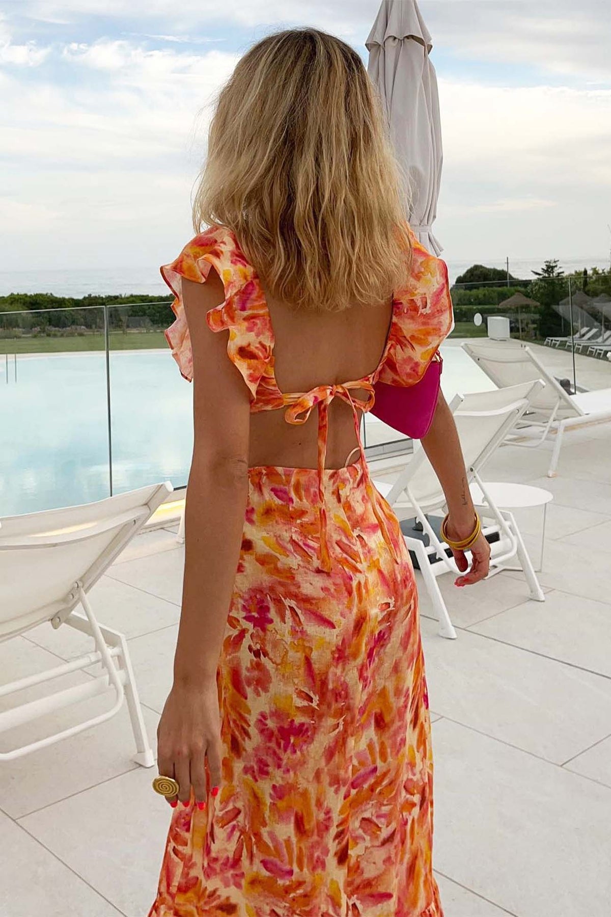 Orange floral maxi dress, flowing silhouette with soft ruffle detail