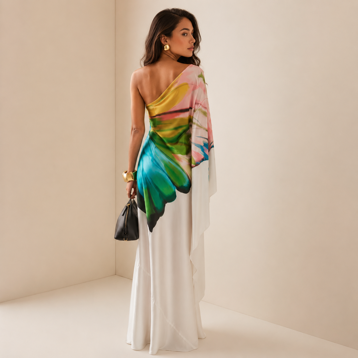 White one-shoulder maxi dress showing the draped sleeve from behind
