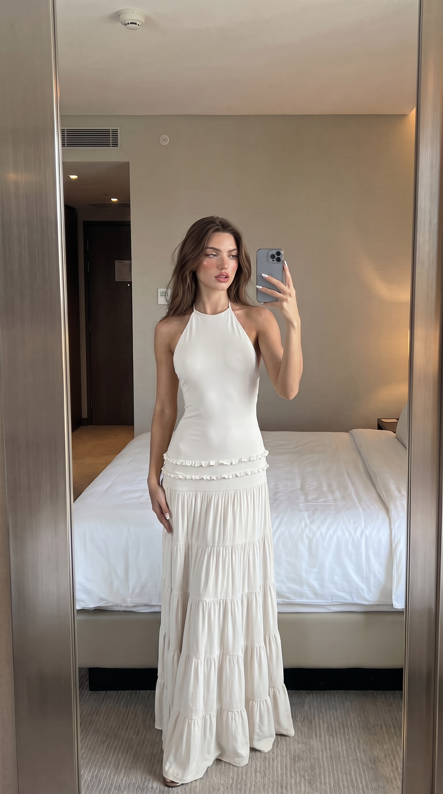 White halter maxi dress with tiered ruffle skirt, mirror view