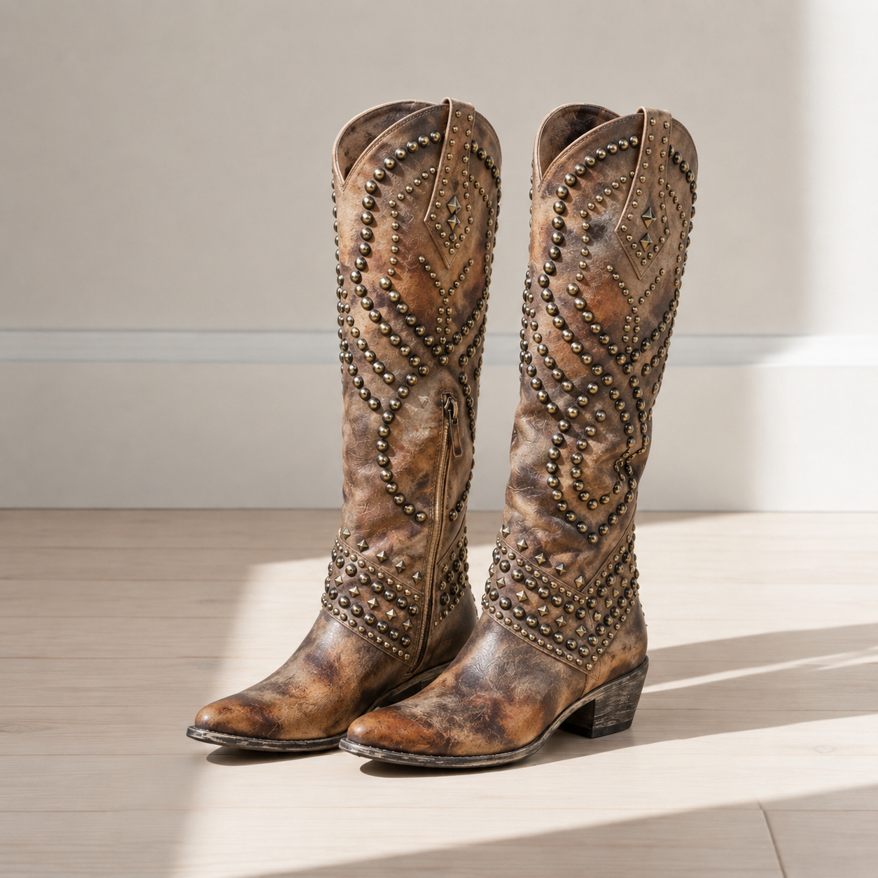 Brown studded western knee-high boots with pointed toe
