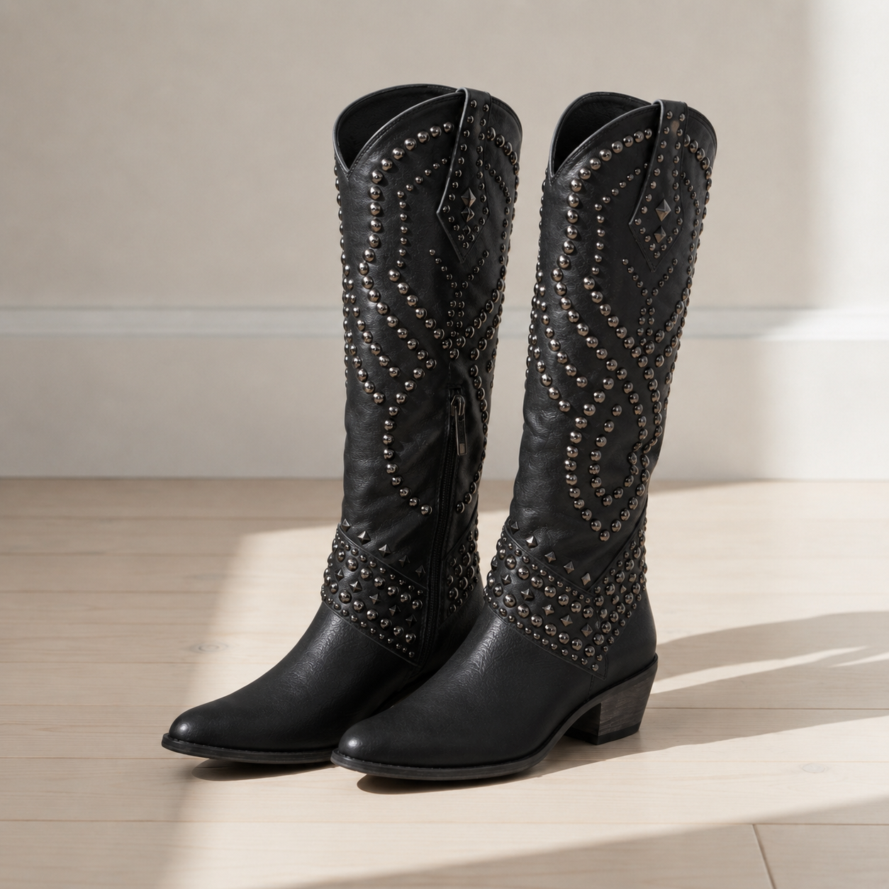 Black studded western knee-high boots with pointed toe