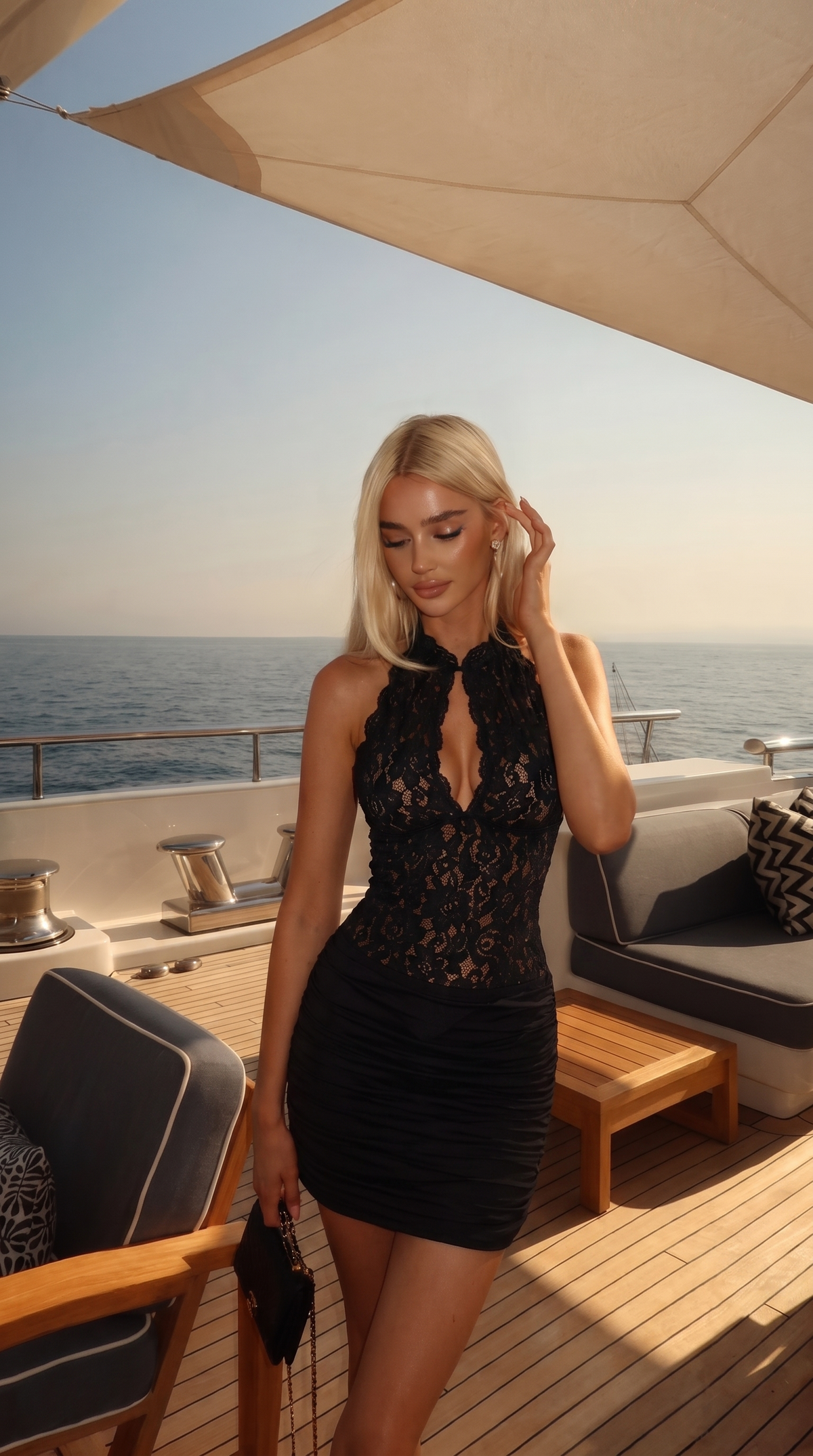 Black lace mini dress with a high neckline, worn oceanside at sunset