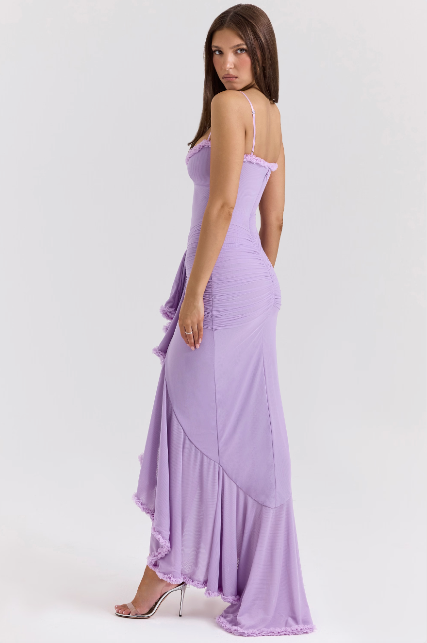Styled shot of the bodycon maxi dress featuring dramatic ruffled slit and spaghetti straps.