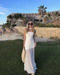 White asymmetrical maxi dress with a strapless neckline