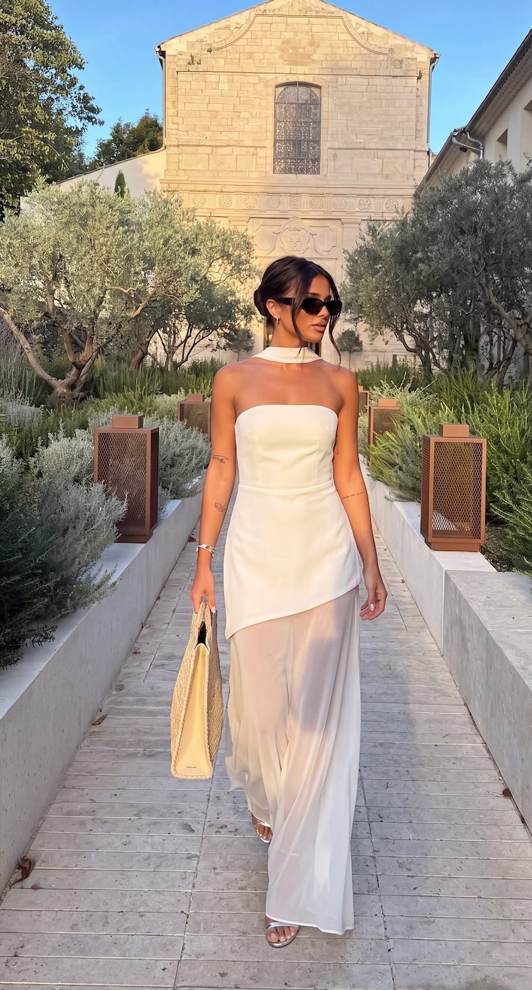 White asymmetrical maxi dress with a flowing, uneven hemline