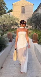 White asymmetrical maxi dress with a flowing, uneven hemline