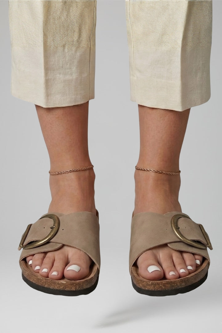 Khaki buckle comfort sandals worn with linen trousers, front view